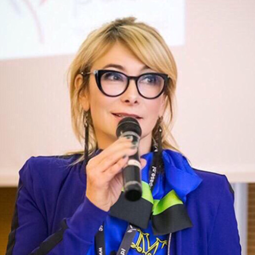 A person with glasses holding a microphone

AI-generated content may be incorrect.